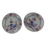 A pair of Chinese Imari porcelain plates, 18th century, each decorated with a stylised flowering