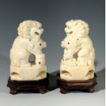 A pair Chinese ivory dogs of fo, circa 1900, signed, each with intricately carved mane, one with