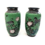 A pair of Japanese cloisonne vases, 19th century, each with a green ground with birds in flight