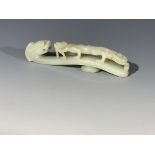 A Chinese jade belt hook, of typical form, with a dragons head and a chilong climbing the body,