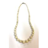 An opal necklace with graduated beads decending from 12mm and separated by graduated crystal faceted
