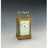 A late 19th century French gilt brass carriage clock, with applied floral banded decoration, the