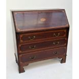 A George III style mahogany bureau, with satinwood crossbanding, the fall front opening to reveal