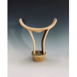 A tribal softwood head or neck rest, with shaped top and carved supports. Height 19cm.