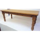 A large pine kitchen table, the rectangular top on turned legs, height 78cm, width 213cm, depth