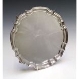 A post war shaped silver tray on four scrolled feet, diameter 25.5cm 15.8ozCondition report: This