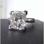An impressive 18ct white gold diamond solitaire ring the bright stone of Princess cut, approaching