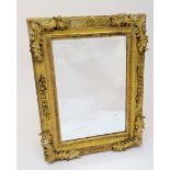 A gilt framed rectangular wall mirror, late 20th century, with foliate and chequer carved frame