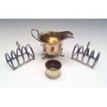 A silver milk jug, a silver napkin ring and a pair of EPNS toast racks