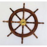 A hardwood and brass mounted ship's wheel, with eight turned square section spokes. Diameter 94cm.