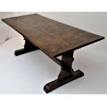 An elm refectory table, the rectangular top on shaped supports joined by a stretcher, height 75cm,