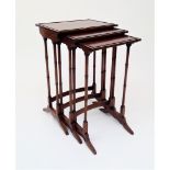A George III style inlaid mahogany nest of three tables, on ring turned supports, height 68.5cm,