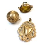 A 9ct gold pomander, a 9ct gold chased prize fob 11.2gm and a gilt seal