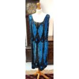 A 1920s black and petrol blue sequined flapper dress.Condition report: There are some bare areas, as