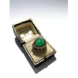 An ornate gold ring set with jade, diamonds and rubies, original retailer's ring box of Mallett, The