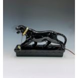 A 1950s Lane & Co. black ceramic lamp in the form of a prowling panther, impressed 'LANE & CO. L.