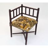 An Arts and Crafts bobbin turned corner chair, height 62cm.