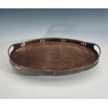 A Newlyn oval copper galleried tray, with twin inset handles, planished finish with central oval