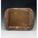 An Arts and Crafts period copper tray, the border repousse decorated with persimmon fruit. 56.5cm