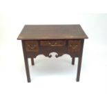 A George III oak lowboy, with crossbanded top and fitted with three chequer strung drawers, above