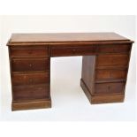 A walnut kneehole desk or dressing table, fitted with an arrangement of nine drawers with brass