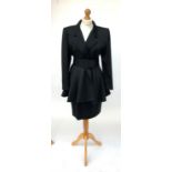 A 1980s power dressing black silk two piece pencil skirt suit by Edina Ronay, the fit and flare