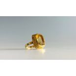 A 14ct gold ring set a citrine in a textured colletCondition report: Ring size N This stylish ring