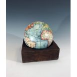 A globe with an associated wooden base, diameter of globe 13.5cm.Condition report: This modern