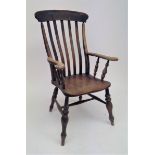 A beech and elm lathe back armchair, 19th century.Condition report: Solid chair, some evidence of