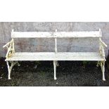A Victorian garden bench, the cast iron ends and centre decorated with ivy covered branch