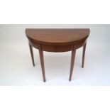A George III mahogany demi lune card table, with square tapering supports, height 70cm, width 91.