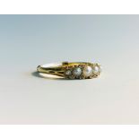 A Victorian gold ring set with five pearls and tiny diamondsCondition report: Ring size Q No