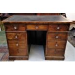 A Victorian walnut pedestal desk, the rectangular top fitted with a leather inset, above an