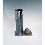 A sculptural metal nut cracker, in three parts, height 24cm.
