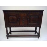 A Jacobean style oak livery cupboard, with a pair of panelled doors on turned legs, height 82cm,