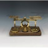 A set of large brass and oak parcel scales, late Victorian, by S Mordan & Co, London, with a matched