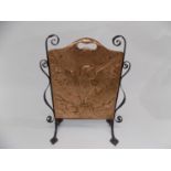 A copper and wrought metal fire screen with embossed eagle decoration. Height 72cm, width 56cm.