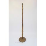 A gilt standard lamp, with raised trailed decoration, height 60cm.
