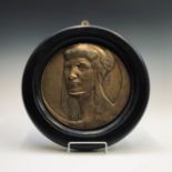 An Art Deco period circular brass plaque after Richard Garbe (1876 - 1957), depicting the head of