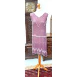A 1920s pink and silver beaded flapper dress, length 92cm.Condition report: There are some missing