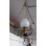 A hanging oil lamp, the wrought metal frame with copper flower head decoration .Overall height