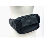 A Gucci black leather belt bag. .