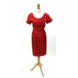 A circa 1950s short sleeved red satin knee length dress, approximate size 10.