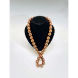 A plain spherical pine bead necklace.