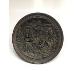A bronzed circular ceramic plaque decorated with classical figures and buildings, impressed mark '