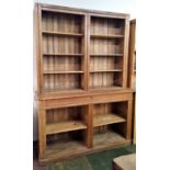 A late Victorian pitch pine bookcase, the upper part enclosing shelves, the lower part with