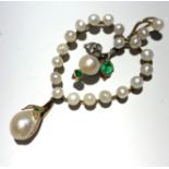 A gold pendant in the form of a heart set with pearls, emeralds and diamonds at the centre a pendant