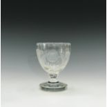 A 19th century glass goblet, engraved with roses and thistles, on squat stem and circular foot.