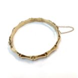 A 9ct gold bamboo moulded hinged bangle. 10gmCondition report: 60.8 x 55.7mm internal