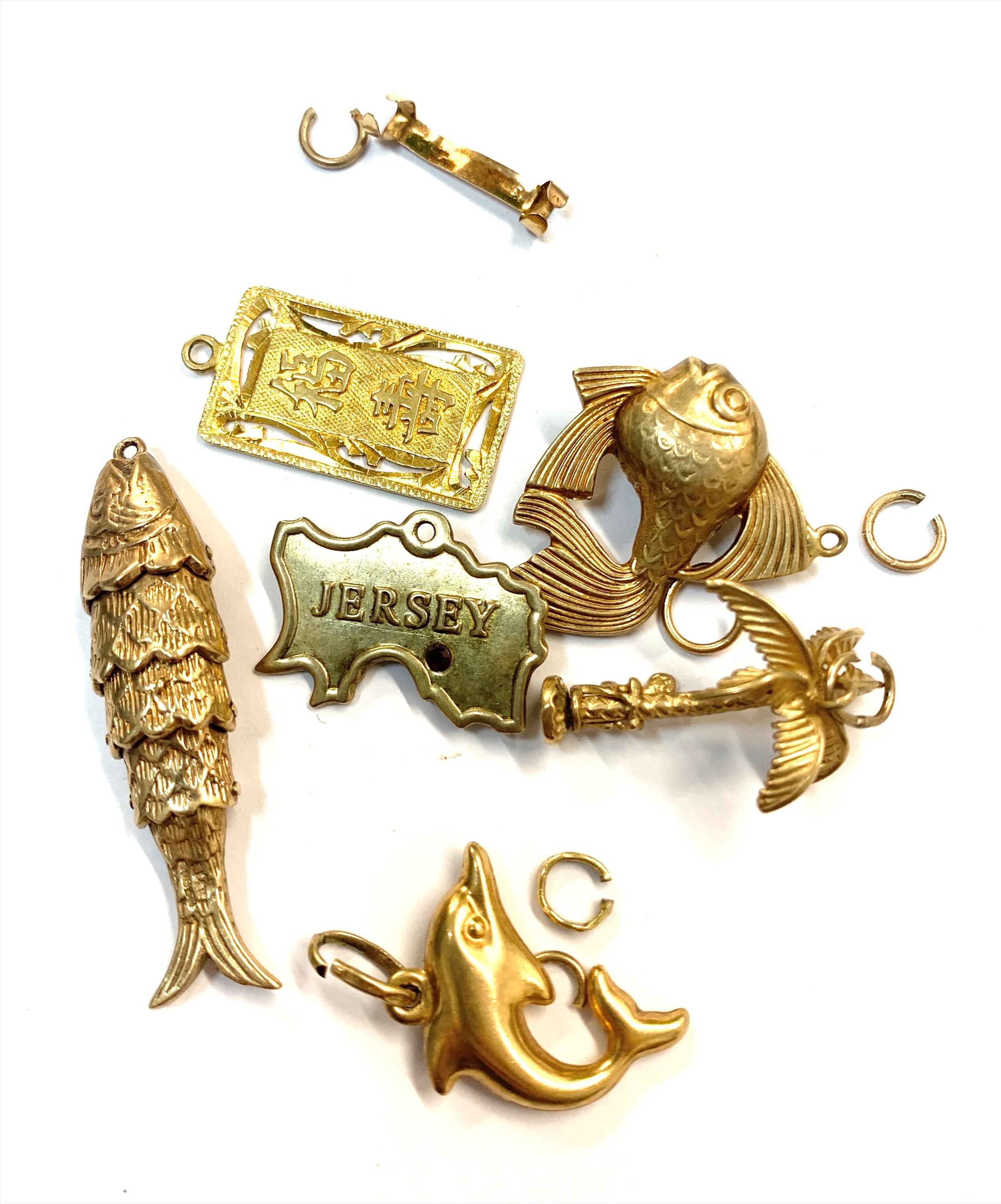 A Chinese high purity gold charm 2.2gm and five other gold charms tog with gold rings 14.2gm